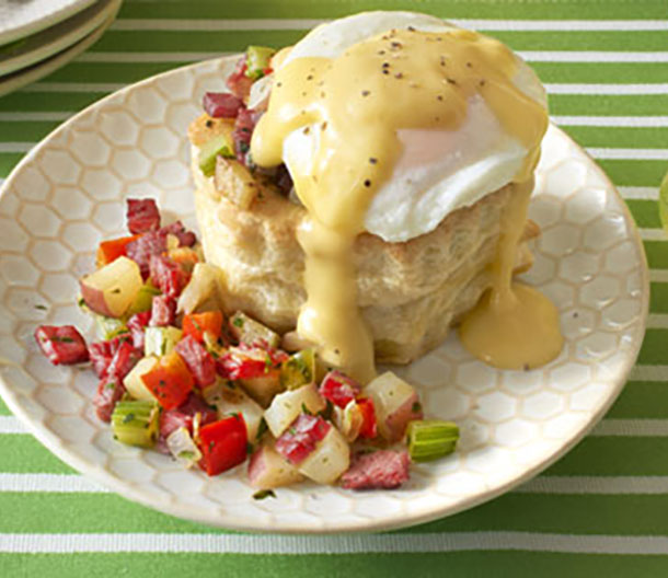 Image of prepared Red Potato-Corned Beef Hash and Eggs in Puff Pastry Shells made with Swanson® Chicken Broth, red potatoes, Pepperidge Farm® Puff Pastry Shells, red bell pepper, onion, celery, corned beef, eggs and Campbell's® Condensed Cheddar Cheese Soup.