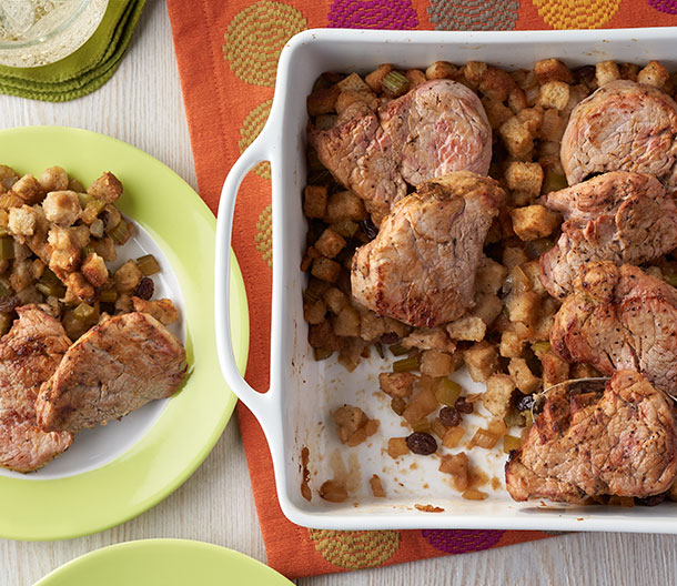 An image of Baked Pork with Apple Raisin Stuffing made with pork tenderloin, Swanson® Chicken Broth, applesauce, Pepperidge Farm® Herb Seasoned Stuffing and raisins.