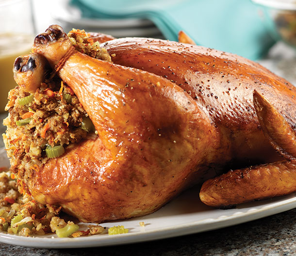 An image of prepared Roasted Chicken with Stuffing & Gravy made with butter. celery, onion, carrot, Pepperidge Farm® Herb Seasoned Stuffing, chicken and Campbell's® Chicken Gravy.