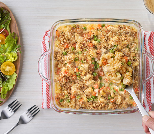 An image of prepared Super Chicken Casserole made with elbow macaroni, Pepperidge Farm® Herb Seasoned Stuffing, Parmesan cheese, butter, Campbell's® Condensed Cream of Chicken Soup, Cheddar cheese, chicken or turkey and peas and carrots.