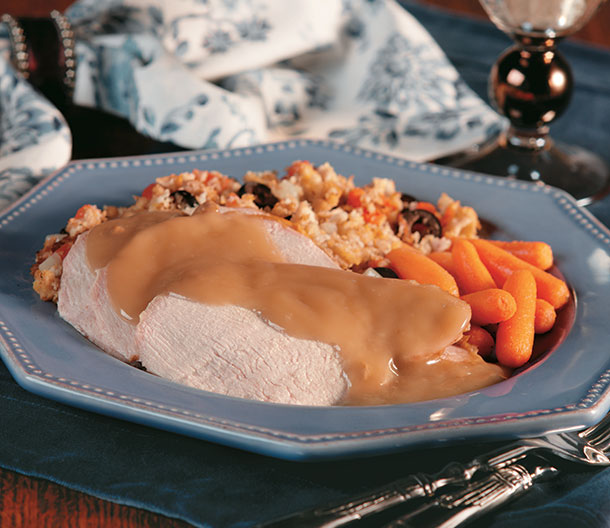 An image of prepared Turkey with Stuffing Provençal made with tomatoes, Campbell's® Condensed Chicken Broth, Pepperidge Farm® Herb Seasoned Stuffing, Pepperidge Farm® Cornbread Stuffing, black olives and turkey.